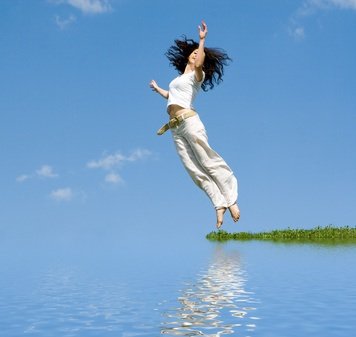 happy young woman is jumping