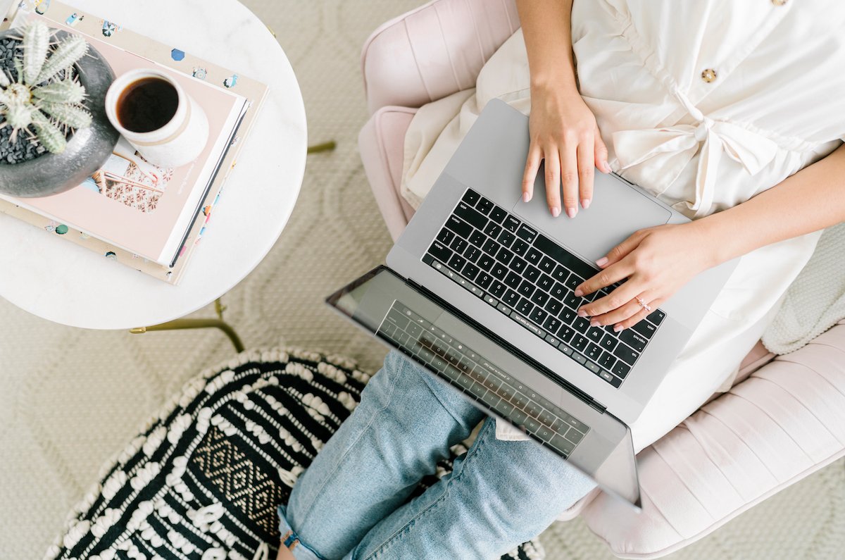 femme sur son ordinateur assise avec un café